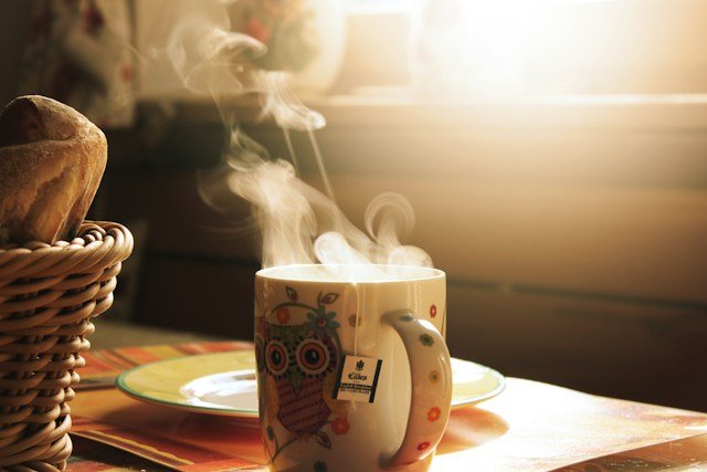 Morning coffee cup near window in morning sunlight